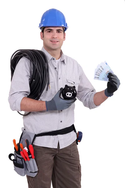 Constructor with bills and piggy bank — Stock Photo, Image