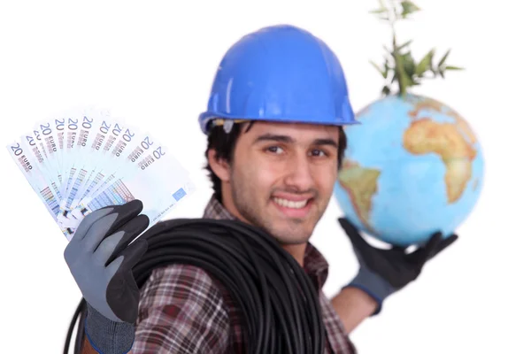 Ambachtsman holding globe en bankbiljetten — Stockfoto