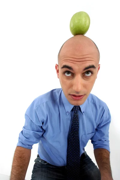 Bald man with apple on the head — Stock Photo, Image