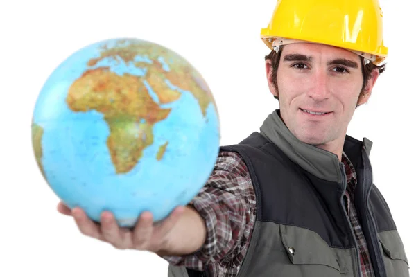 Workman with globe in hand — Stock Photo, Image