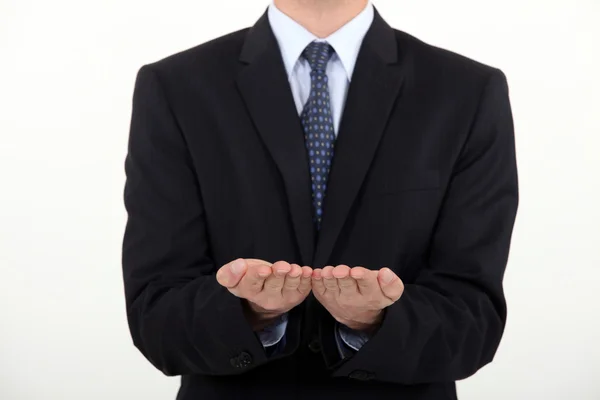 Businessman holding his hands straight palm-side up — Stock Photo, Image