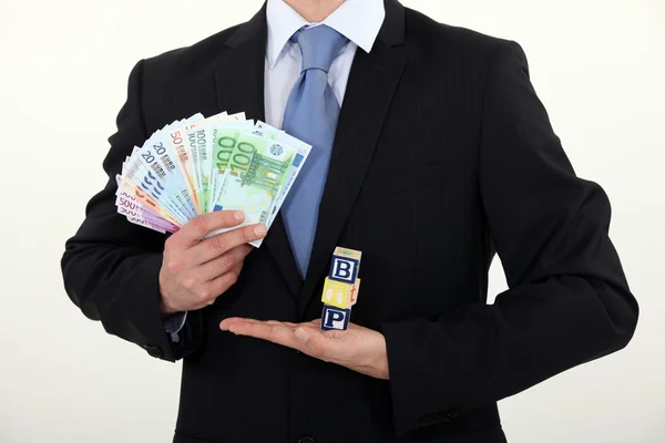 Businessman holding cash — Stock Photo, Image
