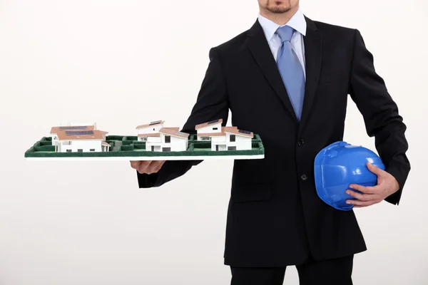 Architect with a model housing estate — Stock Photo, Image