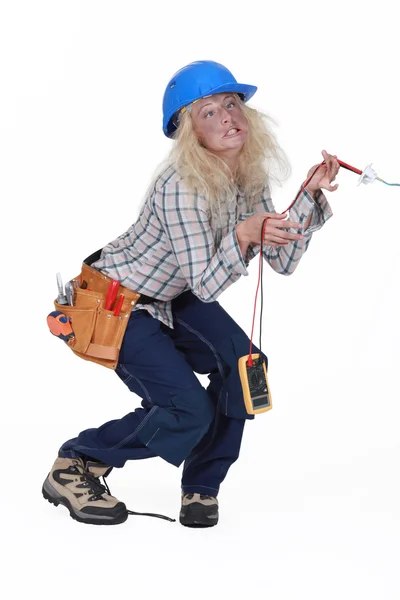 Female electrician getting a shock — Stock Photo, Image