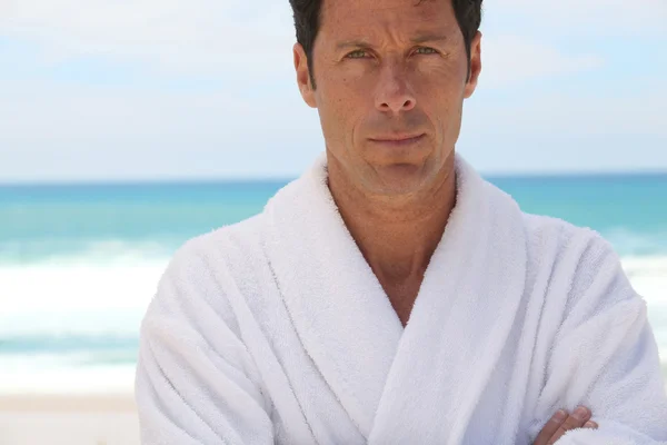 Mature man in white bathrobe — Stock Photo, Image