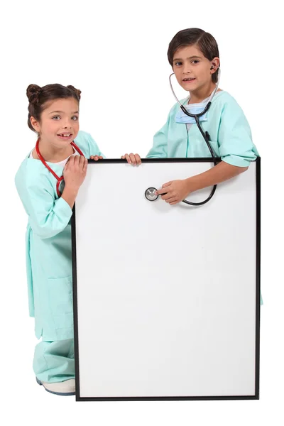 Brother and sister dressed as doctors Royalty Free Stock Images