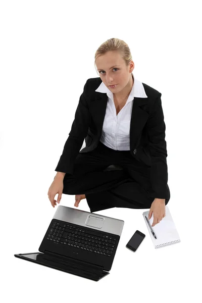 Businesswoman on the floor with computer Stock Photo