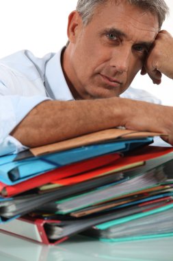 Man with pile of paperwork clipart