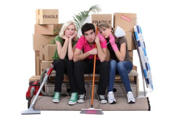 Unhappy housemates cleaning their flat before moving out clipart