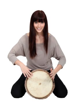 Brunette playing bongo drum clipart