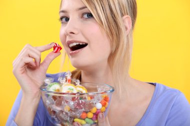 Woman eating candy clipart