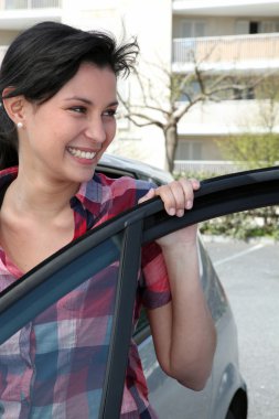 Young Asian woman getting in her car clipart