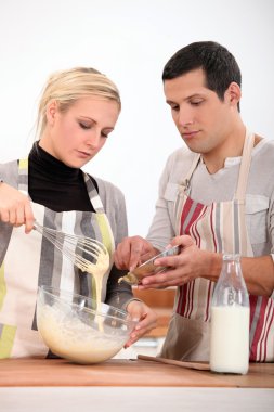 Couple preparing recipe clipart