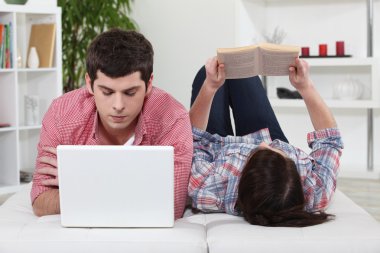 Boy and girl looking at computer clipart