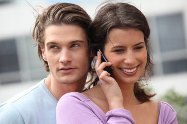 Man eavesdropping on his girlfriend's conversation clipart