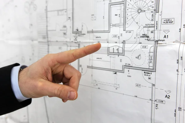 Architect pointing to floor plans — Stock Photo, Image