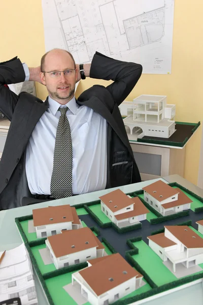 Architect with a model housing estate — Stock Photo, Image