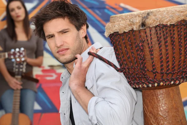 Young man carrying a djembe — Stock Photo, Image