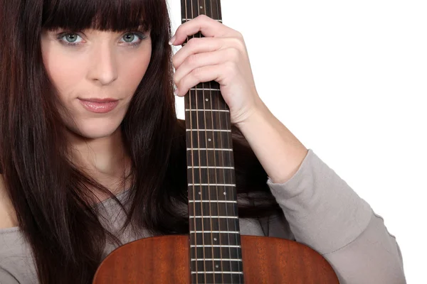 Brunette holding acoustic guitar — Stock Photo, Image