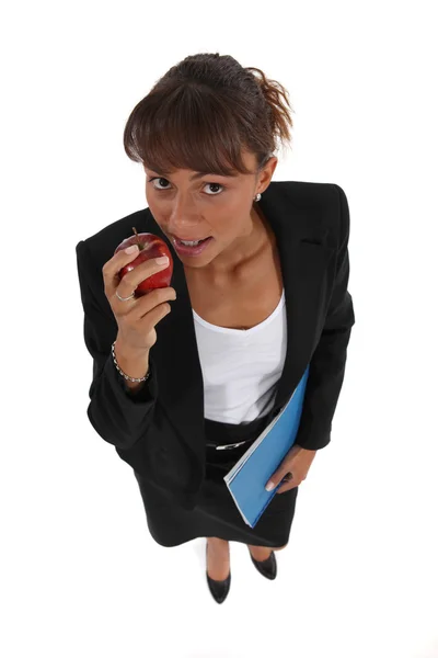 Businesswoman eating an apple — Stock Photo, Image