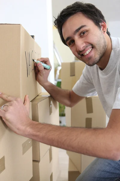 Man marking cardboard boxes — Stock Photo, Image
