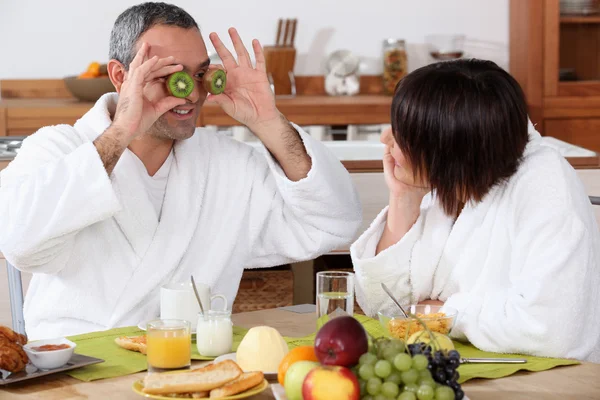 Couple having breakfast in bathrobe — Stock Photo, Image
