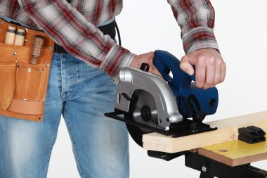 Mason using circular saw clipart