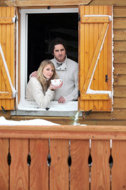 Couple staying in wooden chalet clipart