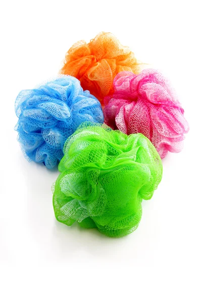 Four colorful shower scrubbers — Stock Photo, Image