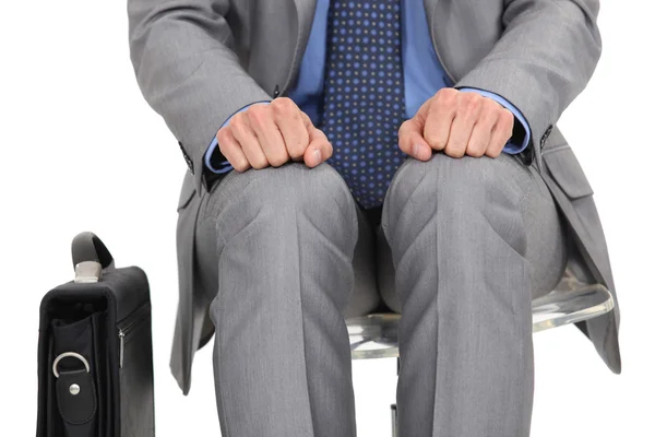 Businessman waiting at station with briefcase by his side — Stock Photo, Image
