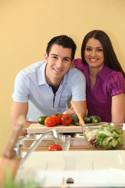 幸せなカップルの野菜をチョップ — ストック写真