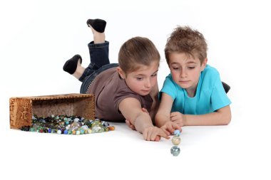 Children playing with marbles isolate on white background clipart