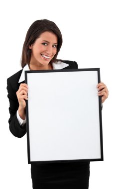 Smart young woman holding a blank board ready for your text clipart