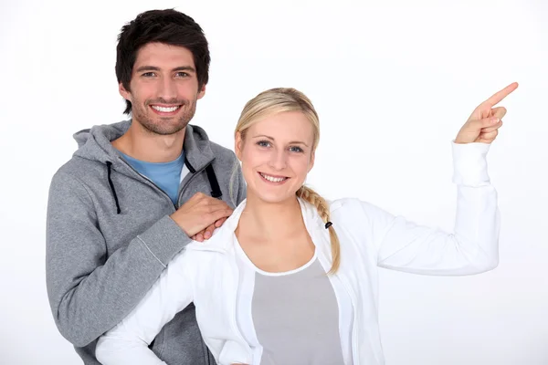 Casual couple pointing — Stock Photo, Image