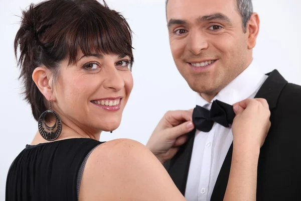 Woman putting bow tie to man — Stock Photo, Image