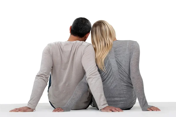 Stock image Couple turned back beholding sunset on beach