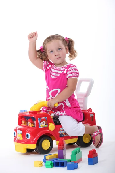 Girl on a toy car — Stock Photo, Image