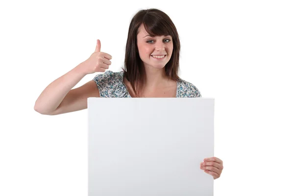 Brunette satisfied with white panel — Stock Photo, Image