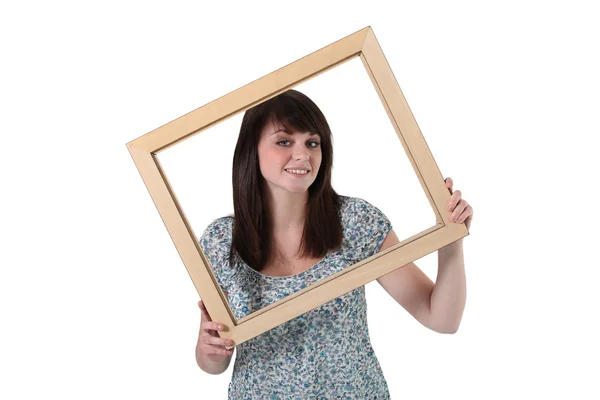 Brunette holding empty frame — Stock Photo, Image