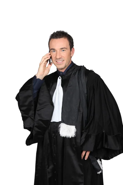 University don in graduation robes on cellphone — Stock Photo, Image