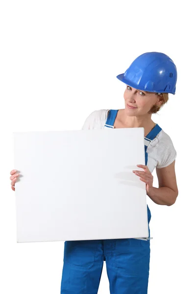 Blond woman wearing hard hat and overalls — Stock Photo, Image