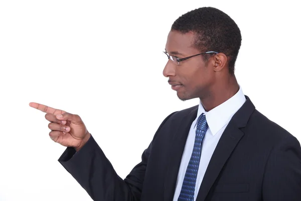 Profile shot of a man in a suit pointing his finger — Stock Photo, Image