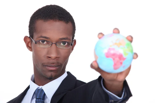 Businessman holding a globe — Stock Photo, Image