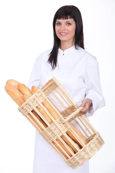 Baker with basket of bread — Stock Photo, Image