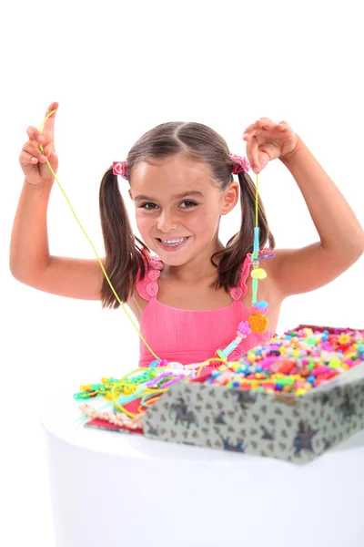 Girl making a bead necklace Royalty Free Stock Images