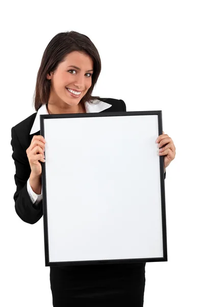 Smart young woman holding a blank board ready for your text Stock Image