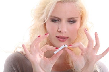 Woman breaking a cigarette clipart