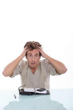 Man pulling his hair out over a personal organizer clipart