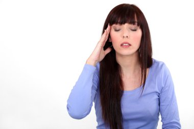 Woman suffering from a headache clipart