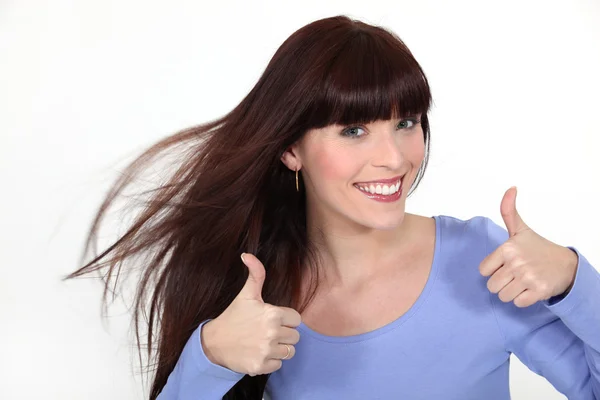 Brunette giving thumbs-up gesture — Stock Photo, Image